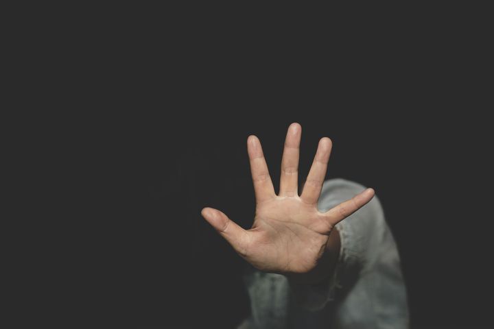 woman raised her hand for dissuade, campaign stop violence against women. International Women's Day